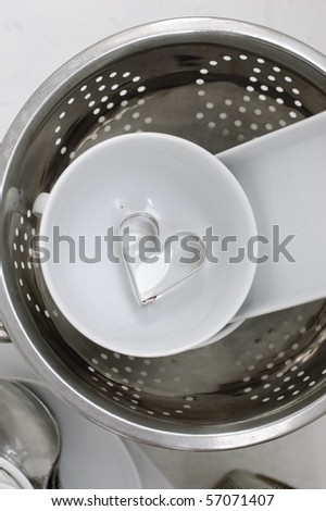 White ceramic and metal dishes on a white painted wooden floor