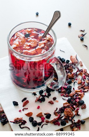 Hot vitamin drink from dried fruits and berries in a transparent cup.