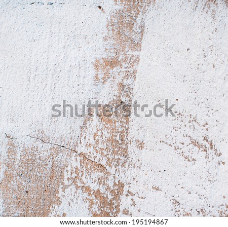 Abstract background, painted white plaster wall, brown texture, paint strokes and cracks.