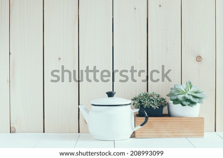 Vintage home arrangement, summer plants and enamelware on a barn wall background, soft pastel colors.