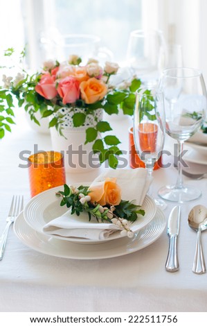Elegant festive table setting with colorful flowers, cutlery, candles. Wedding table decoration.