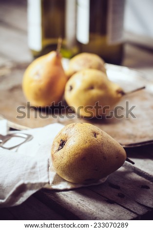 Vintage still life, ripe yellow pears, cupronickel trays on a wooden board