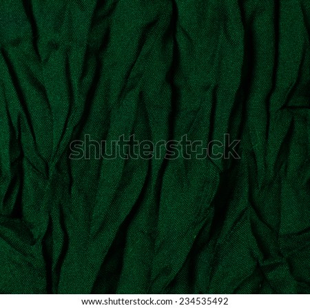 Texture of crumpled green natural fabric, close-up