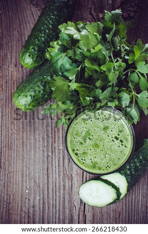 Spring detox diet, cucumber juice and parsley on an old wooden board, vegan food, copy space