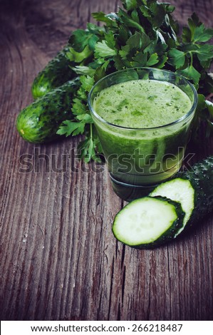 Spring detox diet, cucumber juice and parsley on an old wooden board, vegan food, copy space