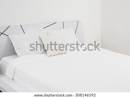 Interior of white bedroom, new linens on the bed in the hotel room