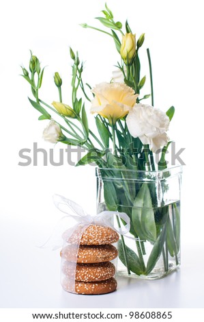 Bouquet of Yellow Eustomas and delicious biscuits on a white background
