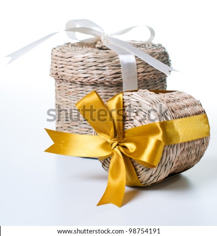 Two wicker box with ribbons of various sizes on a white background