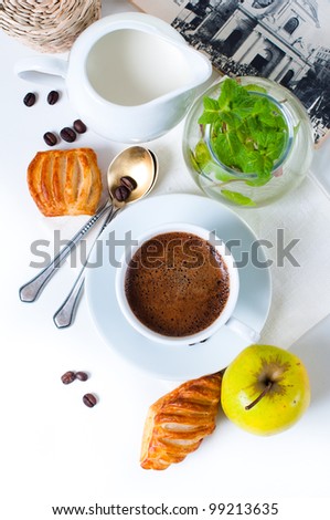 Fresh appetizing breakfast, coffee, pastries and fruits on a white background