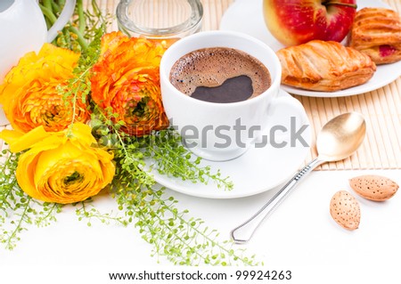 Elegant fresh breakfast: coffee, fruit, pastries, and flowers on a white background