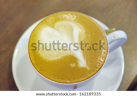 Coffee leaf shaped milk froth.
