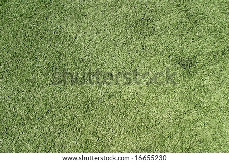 Green artificial lawn on a sports field for football