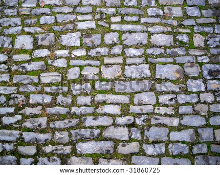 Old gray medieval weathered cobblestone way in Germany.