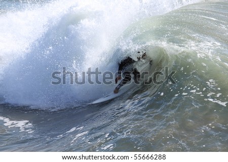 Surfer riding a wave in the Pacific Ocean