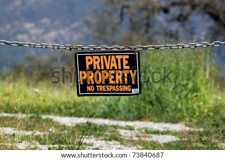 black orange white private property hanging sign
