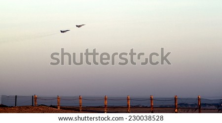 lift off two fighter jets over beach near sunset