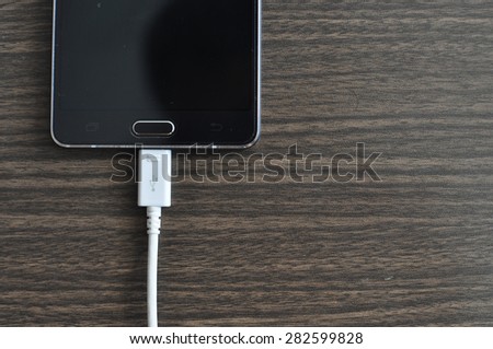 Smartphone Charging On Wood background