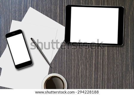 Smartphone, tablet, coffee cup, pen and page on wood background with copy space and text space