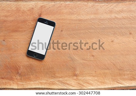 Smartphone on wood background with copy space and text space