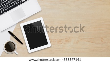 Office workplace with text space ,Wooden table with office supplies tablet,laptop and coffee cup, top view