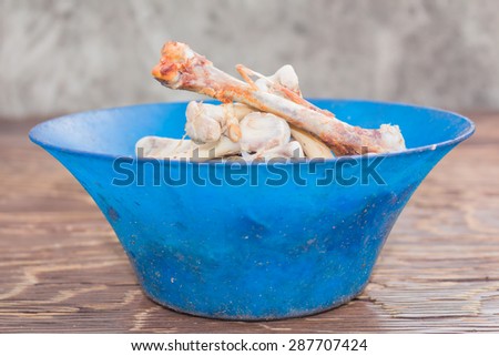 Dog food, Chicken bone on the plate background.