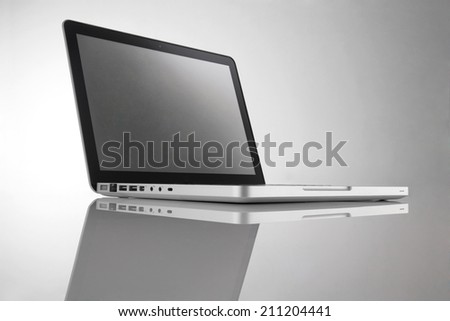 Gray portable computer with clipping path. Side view.  Very large depth of field.