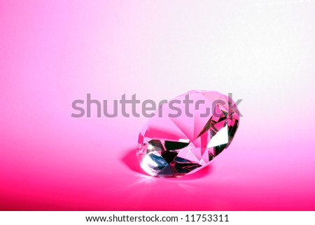 Horizontal Image of a Pink Gemstone in a Brilliant Diamond Cut Against a Pink Background