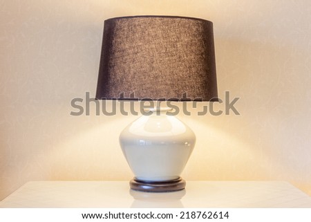Table lamp and its shadow on wallpaper in the bedroom for decoration