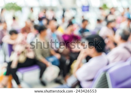 Blurred image of crowd people sitting in departure lounge of terminal Airport.