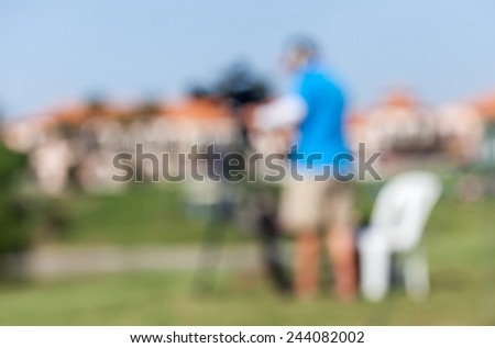 Blurred image of sport photographers working at the golf tournament for live  broadcasting.