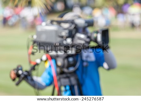 An unidentified sport photographer is working during golf tournament in golf course for live broadcasting.