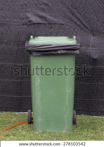 The grunge green plastic bin with recycle bag for clean environment concept.