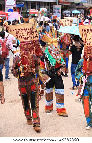 LOEI PROVINCE,THAILAND- JUNE 11:Unidentified men wear ghost costumes at Ghost Festival (Phi Ta Khon - a masked procession celebrated by Buddhist) at Dan Sai district in Loei Province on June 11, 2013.