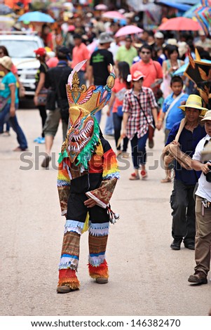 LOEI PROVINCE,THAILAND- JUNE 11:Unidentified men wear ghost costumes at Ghost Festival (Phi Ta Khon - a masked procession celebrated by Buddhist) at Dan Sai district in Loei Province on June 11, 2013.