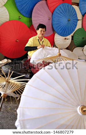 CHIANG MAI, THAILAND-JANUARY 20 : 30th anniversary Bosang umbrella festival,Women in traditional costume during the annual Umbrella festival at San Kamphaeng. on Jan.20, 2013 in Chiang Mai, Thailand.