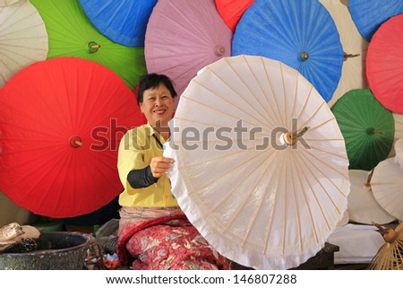 CHIANG MAI, THAILAND-JANUARY 20 : 30th anniversary Bosang umbrella festival,Women in traditional costume during the annual Umbrella festival at San Kamphaeng. on Jan.20, 2013 in Chiang Mai, Thailand.