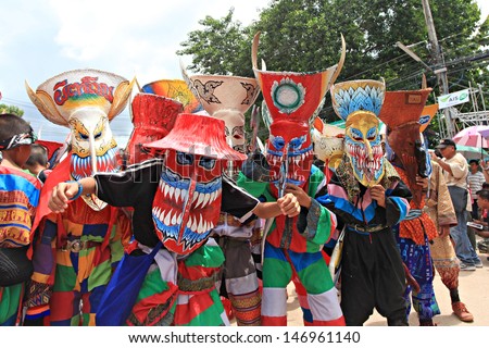 LOEI PROVINCE,THAILAND-JUNE 11:Unidentified men wear ghost costumes at Ghost Festival (Phi Ta Khon - a masked procession celebrated by Buddhist) at Dan Sai district in Loei Province on June 11, 2013.