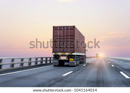 Truck on highway road with red  container, transportation concept.,import,export logistic industrial Transporting Land transport on the asphalt expressway with sunrise sky