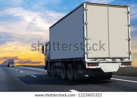 Small White Truck on highway road with  container, transportation concept.,import,export logistic industrial Transporting Land transport on the asphalt expressway Against Sky During Sunset