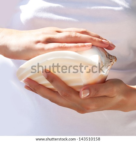 Seashell in the gentle hands