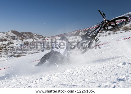 Snow biker downhill in winter mountains Tien Shan (series sport, mountains, extreme, horses, teenagers)