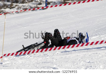 Snow biker downhill in winter mountains Tien Shan (series sport, mountains, extreme, horses, teenagers)