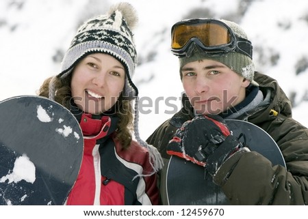 A lifestyle image of two young adult  snowboarders (series sport, mountains, extreme, horses, teenagers)