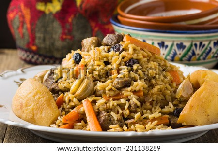 Traditional middle eastern rice dish with lamb meat, carrots, onions, raisins, quince and lots of spices served on white plate