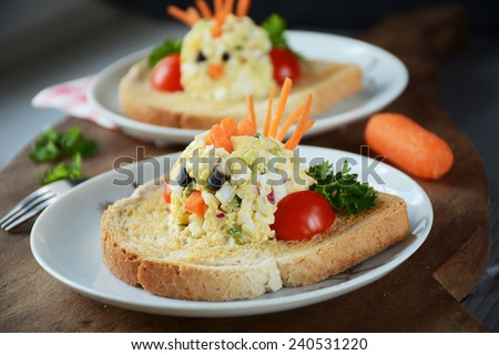 Funny toast for kids breakfast: chicken shaped egg salad on toasted white american bread