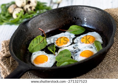 Sunny side up eggs in skillet with swiss chard
