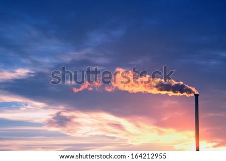 Smoking chimney at sunset