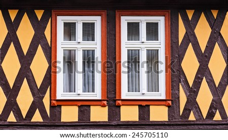 The front side of the  fachwerk house with wooden beams and two symmetrical windows, Wernigerode, Germany