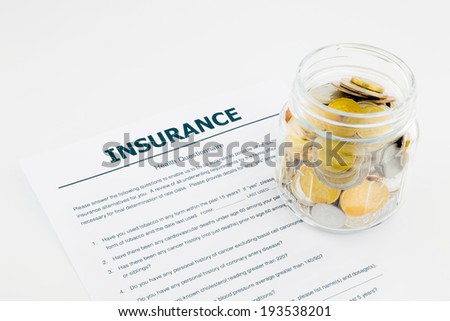 insurance health questionnaire and coins on white background