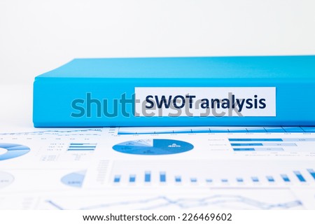 Blue document binders of SWOT analysis place on business graph report concept to evaluate and planning projects